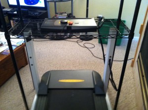 on the treadmill looking down at the front of the platform and the lower shelf and control panel